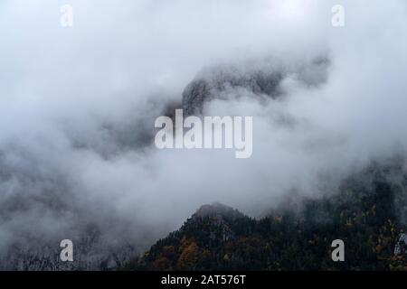 Fog revealing mountain, Ligurian Alps, Piedmont region, Province of Cuneo, north-western Italy Stock Photo