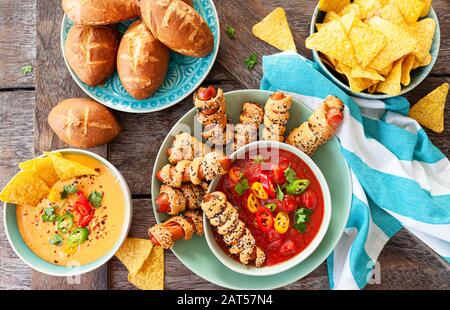 Pigs in a blanket, spicy tomato salsa and other finger food Stock Photo