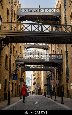Shad Thames in London, UK. Historic Shad Thames near Tower Bridge is an old cobbled street known for it's restored overhead bridges and walkways. Stock Photo