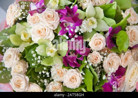 Bouquet of roses and orchids. Beautiful bouquet, floral background. Bright composition of flowers. Stock Photo
