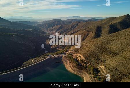 Aerial photography Embalse de Canales Reservoir in Guejar Sierra, province of Granada, Andalusia. Picturesque nature green hills and turquoise water Stock Photo