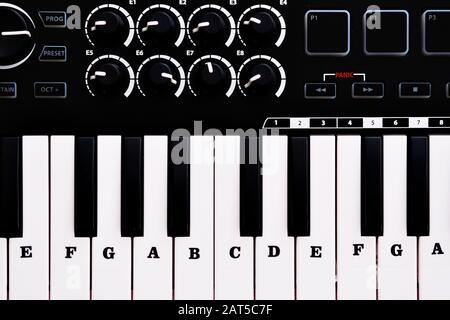 Close up image view from above midi electronic musical keyboard, modern device, full frame background, no people Stock Photo