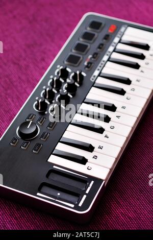 Close up image midi electronic musical keyboard, modern device, vertical image view from above, no people Stock Photo