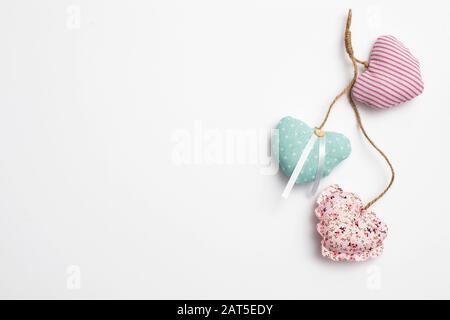 Copy space. Greeting card for Valentine's Day. Multi-colored hearts sewn from fabric with buttons. Stock Photo