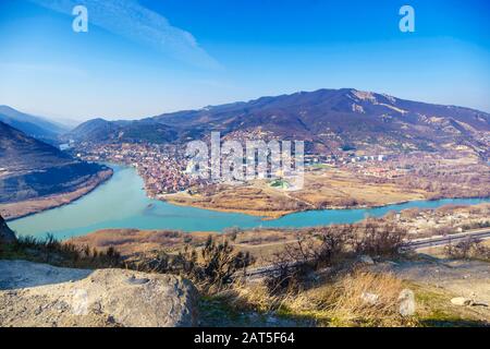 Georgia, Mtskheta, the confluence of the Kura and Aragvi rivers, a muddy and clear river. The view from the Jvari monastery. Caucasian mountains, mona