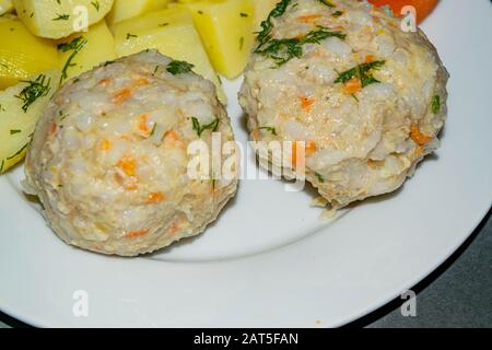 meat meatballs with boiled potatoes and boiled carrots on a white plate. Close up Stock Photo