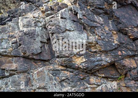 a grey rock face in the sun Stock Photo
