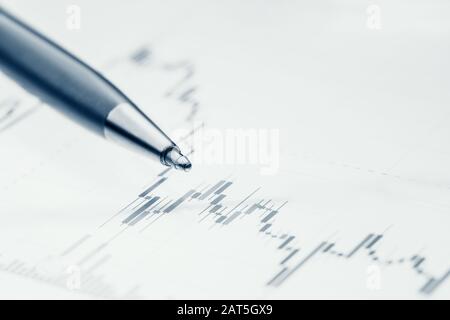 Concept Business and financial. Pen lies on charts of online trade, blue color Stock Photo