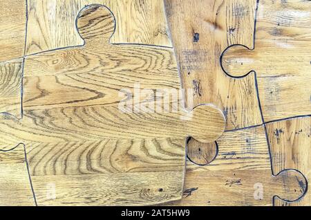 Wooden puzzles. Puzzles from a parquet board. Stock Photo