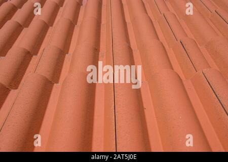Rooftop pattern, arranged orange roof tiles, full frame, house covering Stock Photo