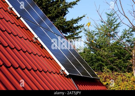 photovoltaic panels on the roof of a single-family house in the countryside Stock Photo