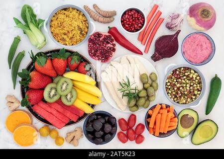 Health food for fitness with foods high in antioxidants, anthocayanins, vitamins, minerals, protein, smart carbs, omega 3 and fiber.Flat lay on marble Stock Photo