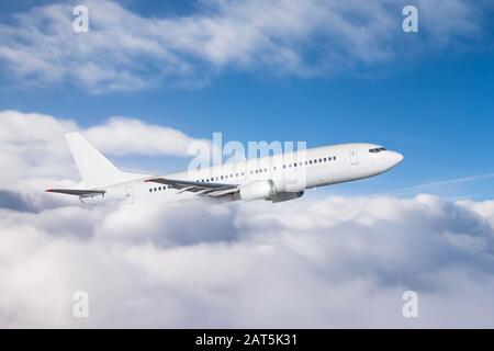 The plane gains altitude flying through a dense layer of clouds, travel flight Stock Photo