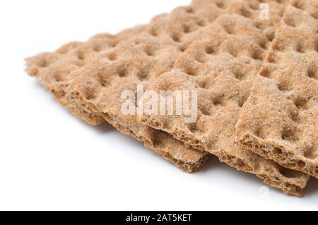 Crunchy crispbread on white background. Selective focus and shallow depth of field. Stock Photo