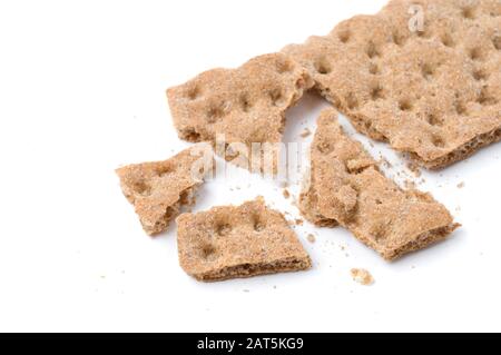 Crunchy crispbread with crumbs on white background. Selective focus and shallow depth of field. Stock Photo