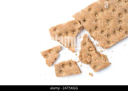 Crunchy crispbread with crumbs on white background. Stock Photo