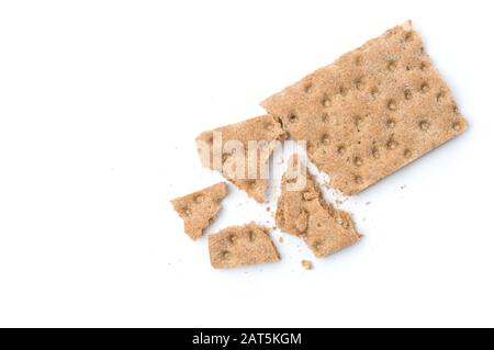 Crunchy crispbread with crumbs on white background. Stock Photo