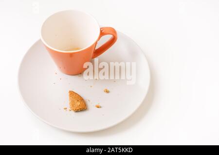 Empty coffee cup and bisquit crumbs on a plate. Stock Photo