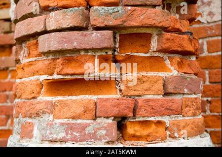 pillar, part of an antique building with a crumbling brick. close up Stock Photo