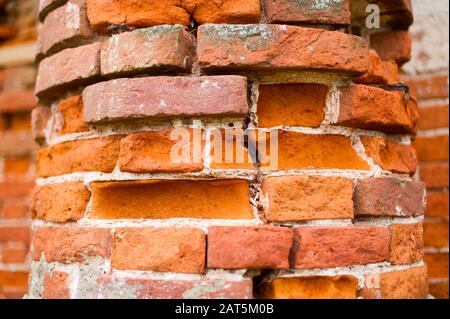 pillar, part of an antique building with a crumbling brick. close up Stock Photo