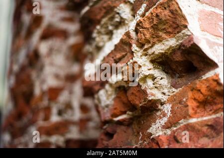 pillar, part of an antique building with a crumbling brick. close up Stock Photo