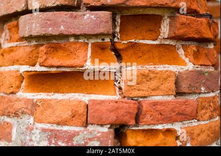 pillar, part of an antique building with a crumbling brick. close up Stock Photo
