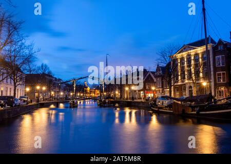 The center of Schiedam with beautiful narrow streets and small canals, photo taken in the evening hours with beautiful blue colors. Province south-Hol Stock Photo