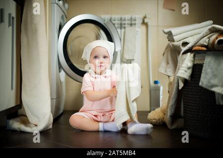 Premium Photo  Baby girl washing clothes by hand in a tin basin. retro  style. hand washing.