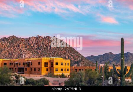 A commercial construction & development site In the Phoenix Arizona area with sunsrt sky and mountains Stock Photo