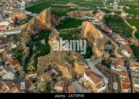 Aerial view of the shell of a mountain former stone quarry with interesting rock formations and orange grooves inside in Monteagudo Spain near Murcia Stock Photo