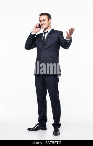 young business man walking and talking on phone while looking to a side on white background Stock Photo