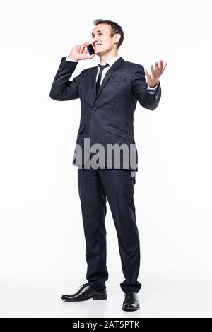 young business man walking and talking on phone while looking to a side on white background Stock Photo