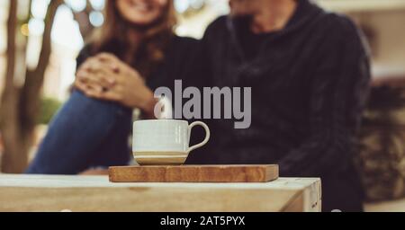 Couple on a date at a coffee shop. Two people sitting together in a cafe during a meeting. Stock Photo