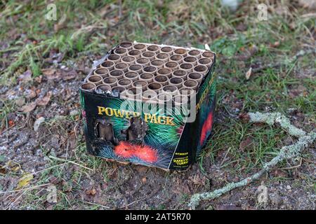 Fired barrage or cake firework left on a field after New Year's celebration Stock Photo