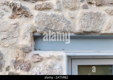 Detail of iron beam acting as window lintel. Rehabilitation of old buildings with present materials Stock Photo