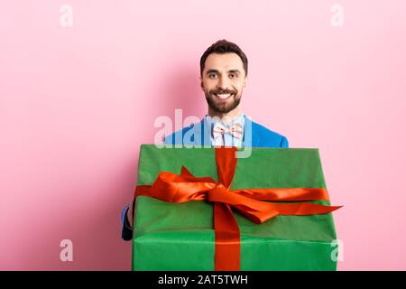 Man formal suit hold gift box. Christmas gift from colleague. Tradition  giving gifts. Businessman excited face hold gift box. Secret santa office  tradition. Celebrate christmas corporate party Stock Photo by ©stetsik  314404120