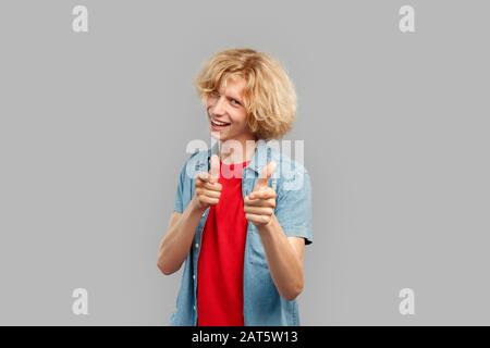 Young man smiling wide and pointing at camera Stock Photo