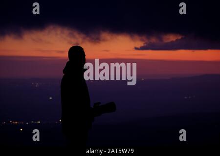 Photographer looking at the valley from a high point in the massif of Montserrat. Anoia. Catalonia. Spain. Stock Photo