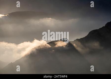 Low lying evening mist over forested mountains. Cadi-Moixero Natural Park. Catalonia. Spain. Stock Photo