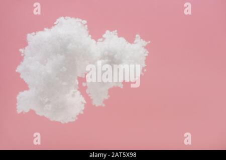 white fluffy cloud made of cotton wool isolated on pink Stock Photo