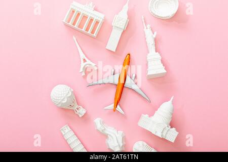 top view of toy plane near figurines from countries on pink Stock Photo