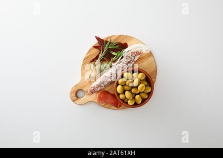 top view of delicious meat platter served with olives on board isolated on white Stock Photo