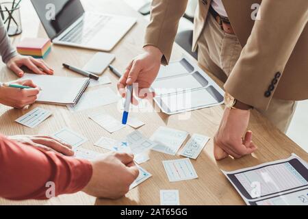 Cropped view of designers developing user experience design with sketches on table Stock Photo