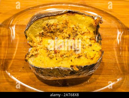 Homemade baked potatoe in foil, Selective focus. Stock Photo