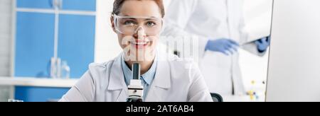 panoramic shot of smiling molecular nutritionist looking at camera Stock Photo