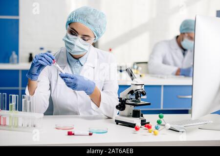 genetic consultant in white coat doing dna test in lab Stock Photo