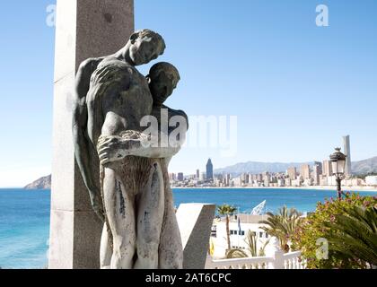 Tribute to the dead at sea human figure sculpture with Playa de Poniente beach in the back (Benidorm, Marina Baixa, Costa Blanca, Alicante, Spain) Stock Photo