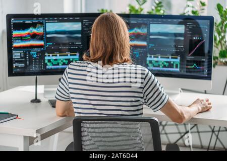 back view of editor working near computer monitors Stock Photo