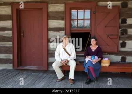 Reenactors rest on a bench at Historic Old Fort Wayne in Fort Wayne, Indiana, USA. Stock Photo