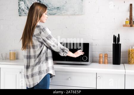 Young Beautiful Woman Using Microwave Oven Stock Photo 317199641